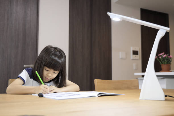 istock studying Japanese girl in dining room (7 years old) 1397973630