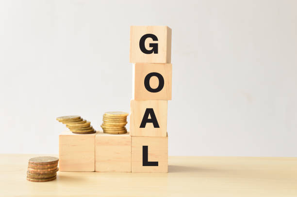istock Stack of coins and wooden blocks with text GOAL 1397974309