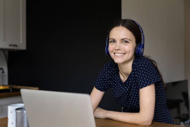 istock Woman lean at table with laptop posing looking at camera 1397975017