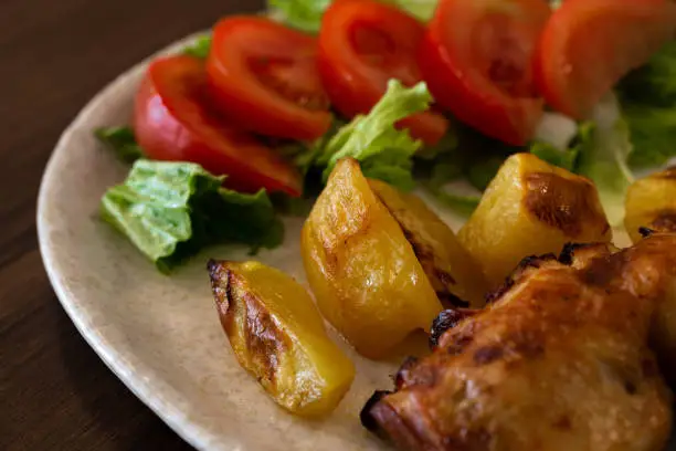 Roasted Chicken with Potatoes and a Tomato Salad, Braga, Portugal.