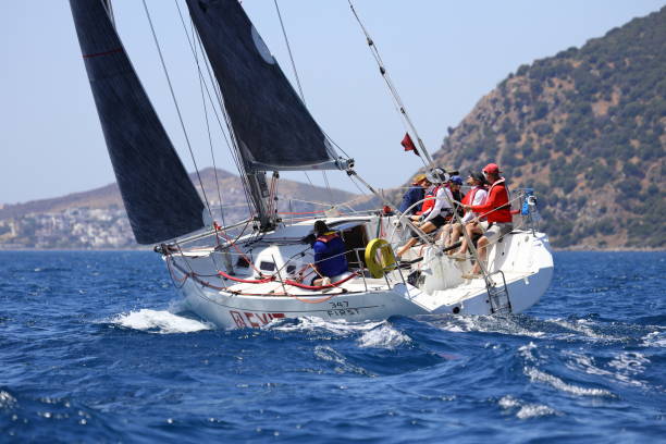 les voiliers naviguent par temps venteux dans les eaux bleues de la mer égée - sailboat storm teamwork competition photos et images de collection