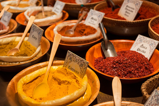 Bowls with assorted spices in medieval market, concept of different flavors in the world