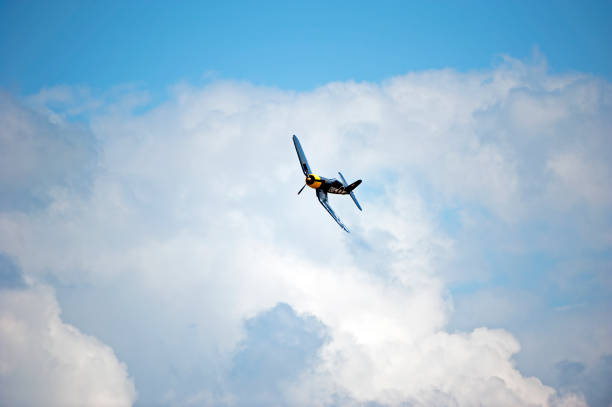 A WW2 airplane against  the evening sky.
