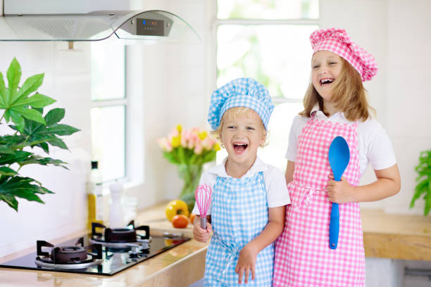 istock Kids cook in white kitchen. Children cooking. 1397981562