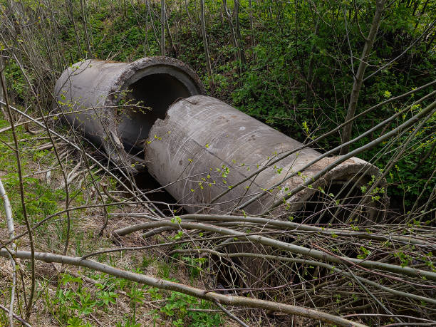 istock Two large, old concrete culverts was thrown into a ditch. 1397983419