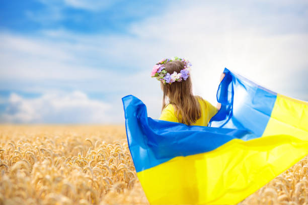istock Pray for Ukraine. Child with Ukrainian flag. 1397987683