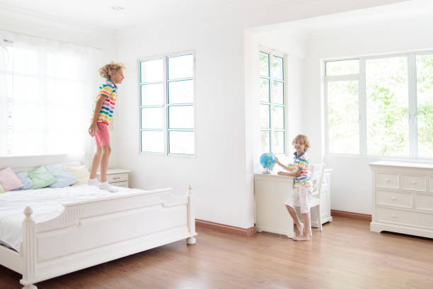 istock Child playing in bed. Kids room. Boy at home. 1397990076