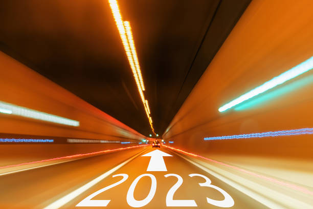 istock 2023 text and arrow forward written on the road in tunnel with blurred light 1397990280