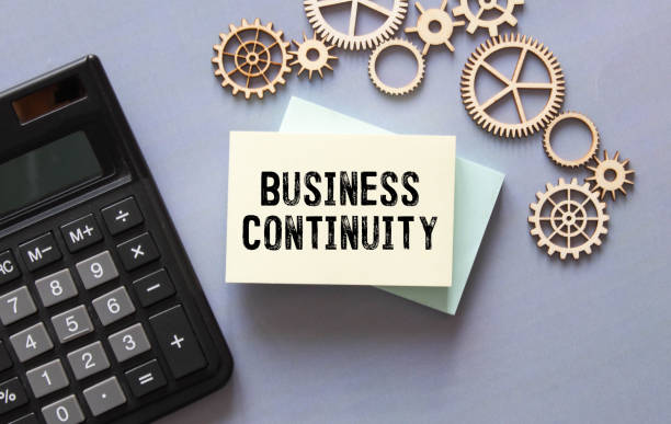 istock Stickers on notebook text BUSINESS CONTINUITY with pen and glasses on the white background. 1397990843