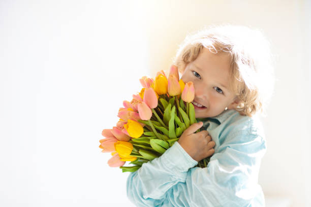 Child holding a small flowers