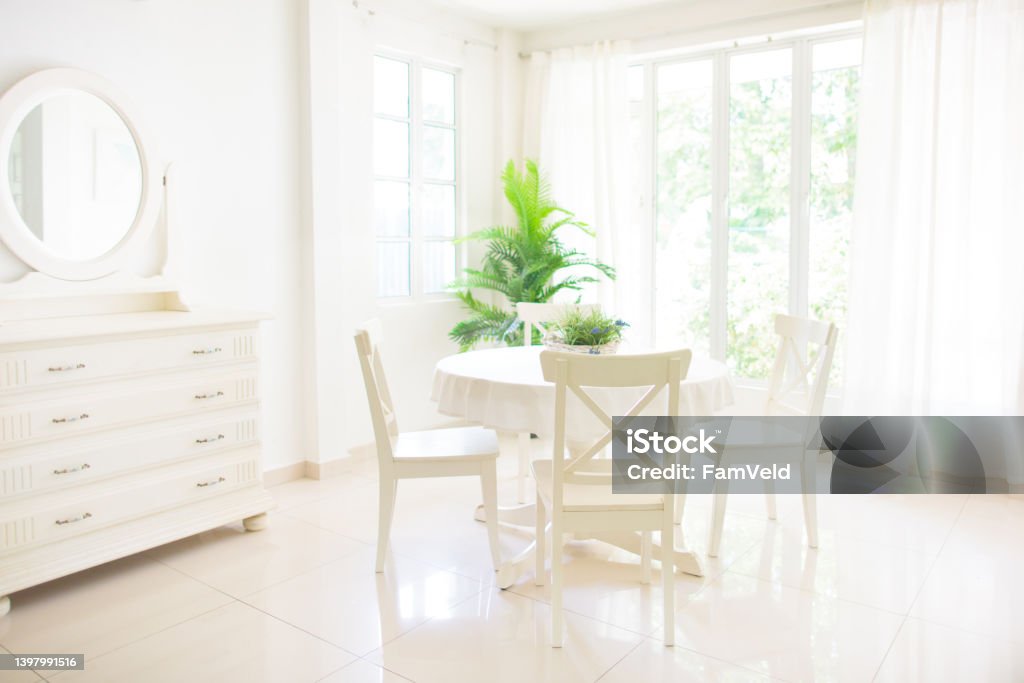 Home interior. Dinning room. Table and chairs. Home interior. Dining room design. Table and chairs in white sunny house. Kitchen breakfast area in family apartment. Breakfast Room Stock Photo