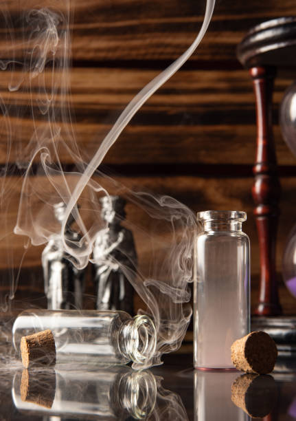istock Small glass with empty cork cap, smoke, and more accessories, rustic wooden background, selective focus. 1397991829