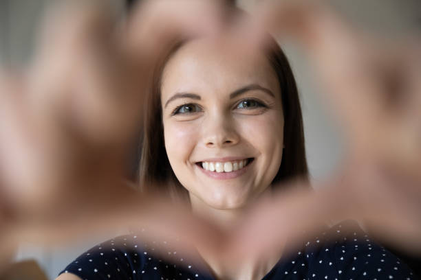istock Woman showing heart shape to camera, close up 1397993263