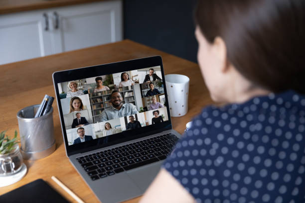 istock Businesspeople engaged in videoconference, laptop screen over female shoulder 1397993265