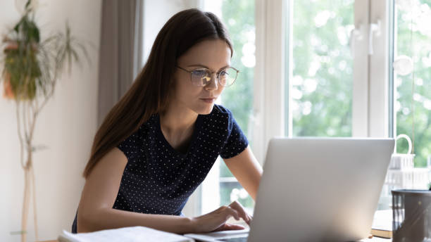 istock Busy student girl in glasses studying use laptop 1397993268