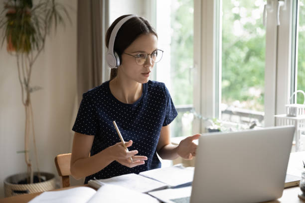 istock Student talks to schoolmate, prepare together for exams through videoconference 1397993280