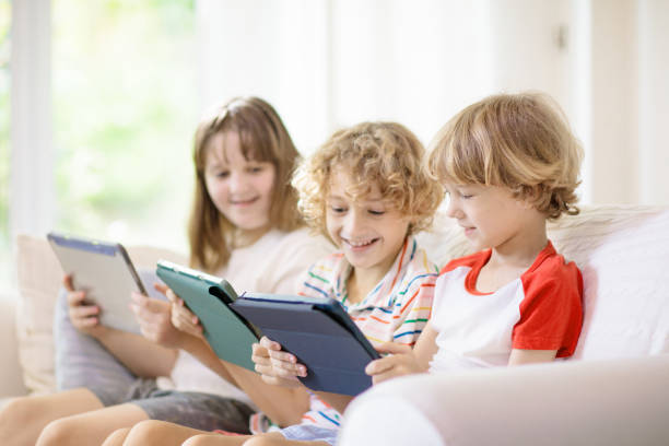 istock Kids with mobile phone. Child with tablet computer 1397993742