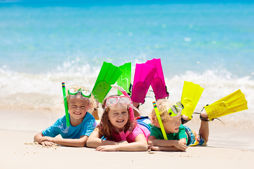 Happy children having fun on a sand beach