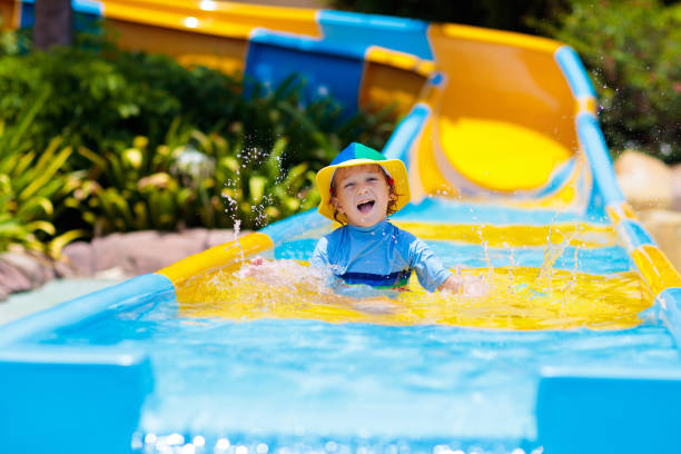 istock Kids on water slide in aqua park. Summer vacation 1397997314