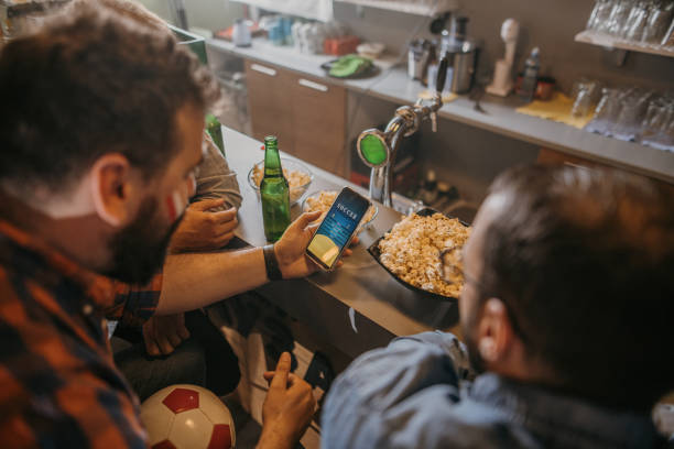 istock Guys betting on their team 1398003755
