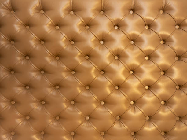 istock Texture of brown beige leather background with capitone pattern, full-frame. Brown retro Chesterfield style. 1398006370