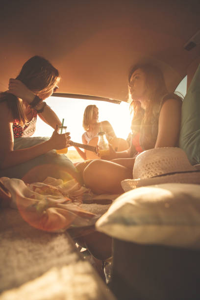 istock Three best friends having fun at the back of a vehicle while making a road trip and camping 1398006539
