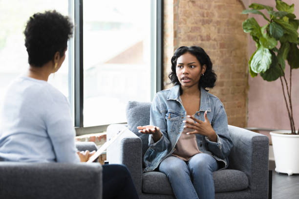 istock Young woman talks with her counselor at school 1398008719