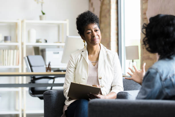 Therapist listens to her patient The therapist sits and listens intently to her patient. Psychiatrist stock pictures, royalty-free photos & images