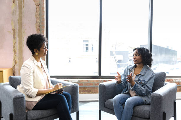 istock Young woman meets with her counselor 1398009304
