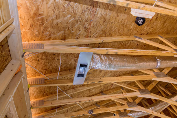 istock Ventilation pipes in silver insulation material hanging from the ceiling inside new building. 1398009478
