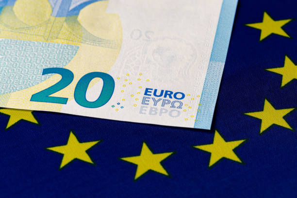 Euro banknote on European Union flag. Economy, financial and banking concept. stock photo