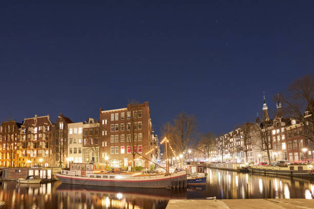 istock Amsterdam city canal at night 1398012817