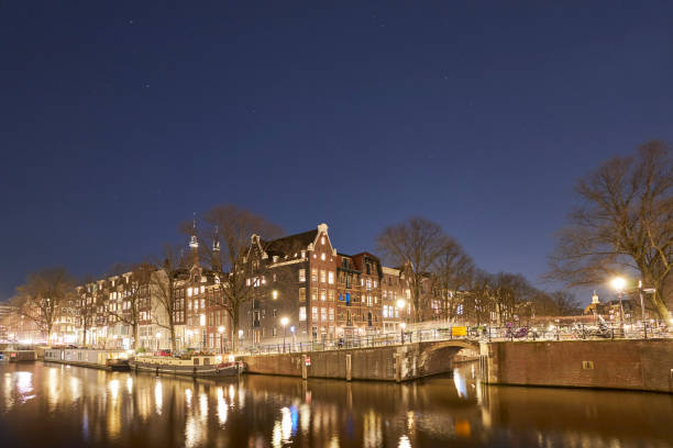 istock Amsterdam canal cityscape at night 1398012819