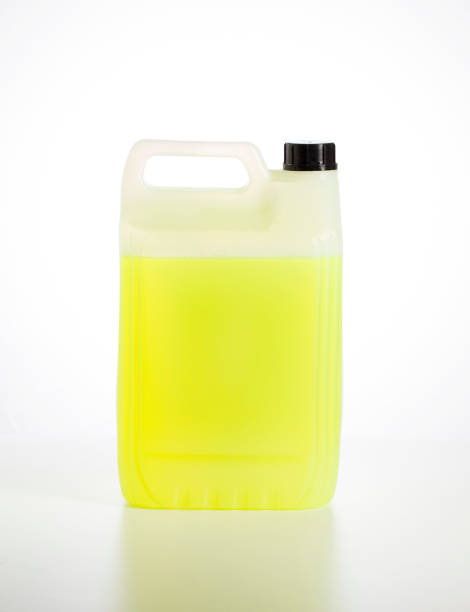 istock Canister with yellow car shampoo concentrate on a white background, isolate. Cleaning a car from dirt, shampoo for a contactless car wash, close-up 1398013230