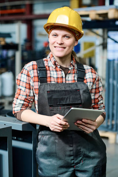 istock Young successful female engineer with tablet standing in front of camera 1398013466