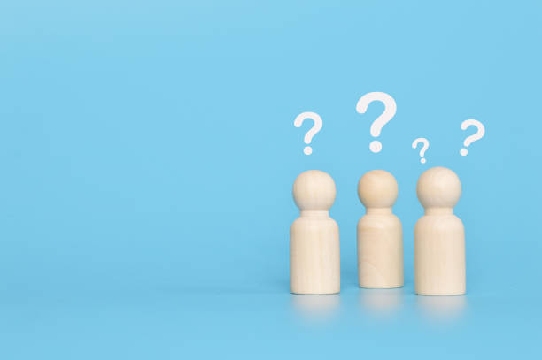 istock Wooden doll figures with questions marks 1398016224