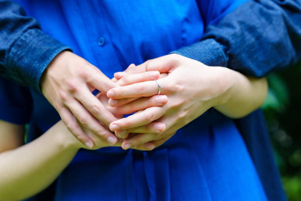 istock Hands of a couple hugging each other 1398016862