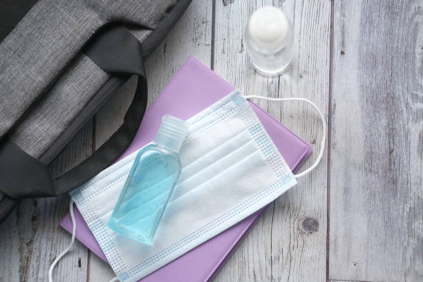 istock Surgical masks, and hand sanitizer on orange background 1398020544