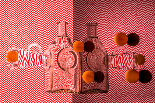 Abstract still life with glassware and balls on a red geometric background