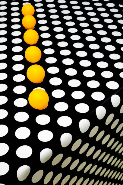 Abstract still life with yellow balls on a black and white background