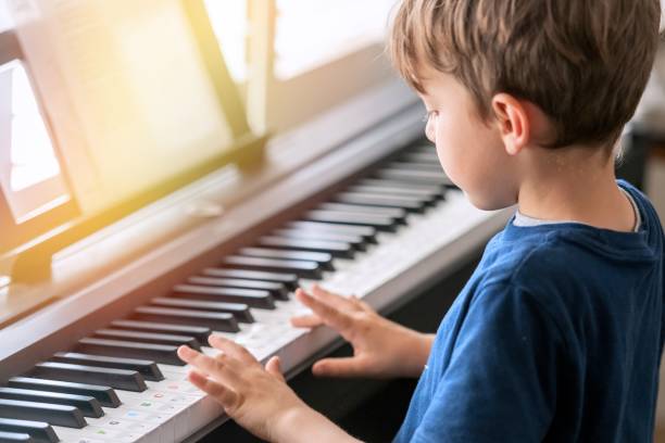 istock Little boy learning how to play piano 1398028506