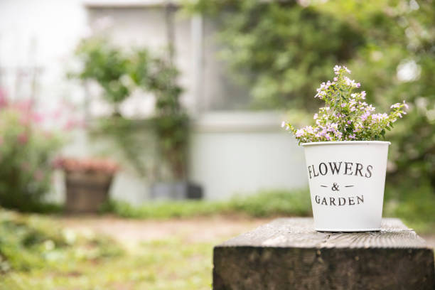 istock A planter is placed on a wooden flower stand and decorated. 1398029255