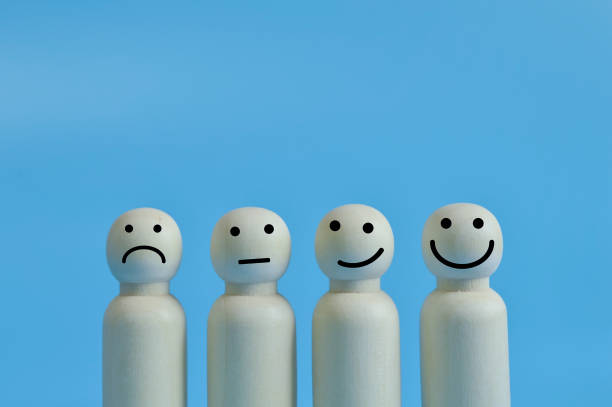 istock Wooden doll figures with emotion face. Customer evaluation and satisfaction concept. 1398032542