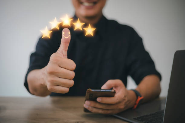 istock Customer experience satisfaction concept. customer hand with thumb up Positive emotion smiley face icon and five star with copy space. Best Excellent Services Rating for Satisfaction. 1398033739