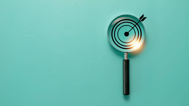 istock Target board inside of magnifier glass for focus business objective on blue background and copy space. 1398033823