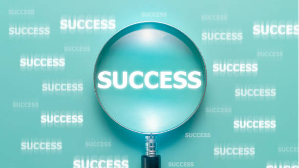 istock success wording inside of Magnifier glass on light blue background, positive thinking mindset concept. 1398033825