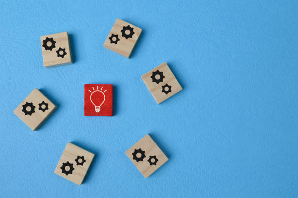 istock Wooden blocks with cogwheel and light bulb symbol 1398036153