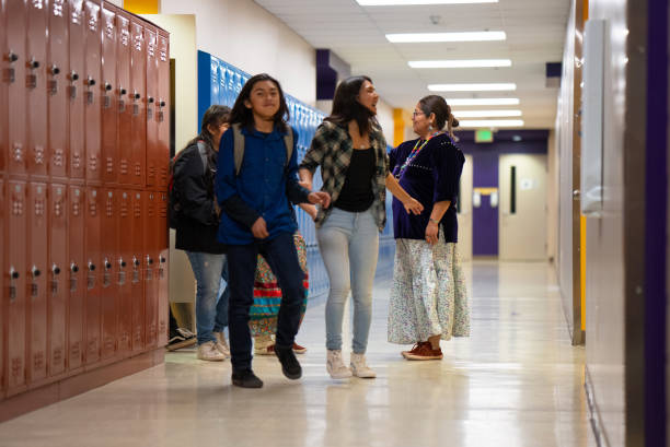 istock Teacher saying goodbye to students outside the classroom 1398036771