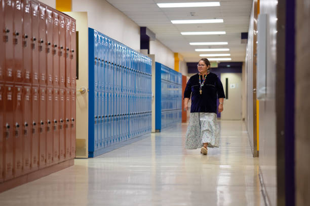 istock Teacher walking and checking the school corridors 1398038078