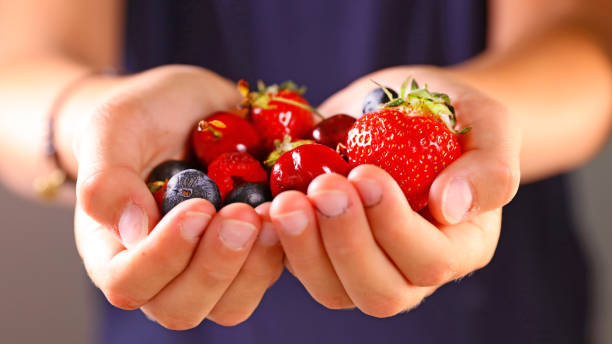 istock children holding fresh berries fruit 1398040862